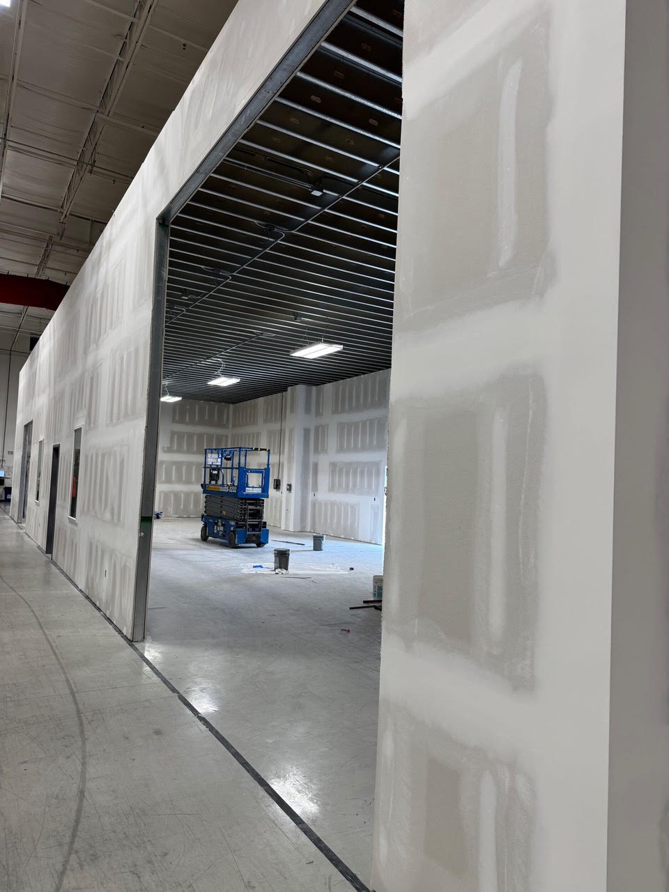 A wide opening through a new wall, looking from the addition into the Teknoware warehouse