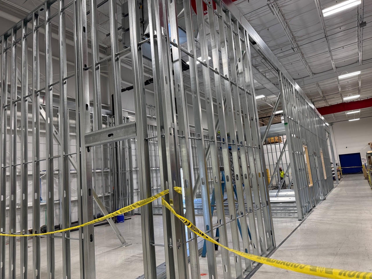 New metal stud walls going up inside the Teknoware warehouse, taped off for safety
